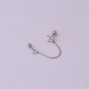 Detail view of silver chain earring featuring a zircon flower and a polished bead stud