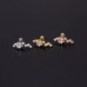 Macro shot of 16G stainless steel labret studs with star-shaped zircon in three metallic colors