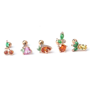 Macro shot of 20G surgical steel fruit earrings set with colorful CZ cherry and pineapple