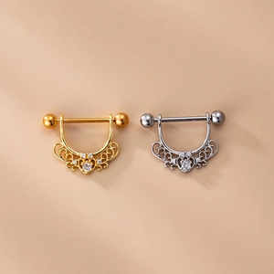 Dettaglio macro di piercing per capezzoli a forma di U in oro e argento con zirconi cubici