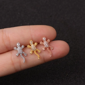 Three-color gecko stud earrings set with zircon micro-pave detailing on finger