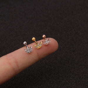 Macro view of tiny crown stud earrings in silver, gold and rose gold with zircon