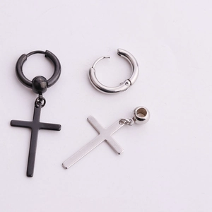 Detail view of punk style stainless steel cross pendant earrings in black and silver finishes