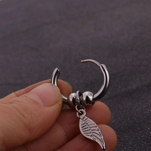 Polished silver stainless steel hoop earrings with hanging leaf pendant and beads detail