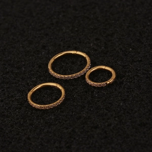 Three-piece gold stainless steel clicker rings with side-set cubic zirconia in various sizes