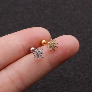 Macro shot of rose gold flower cartilage stud earrings with cubic zirconia inlay
