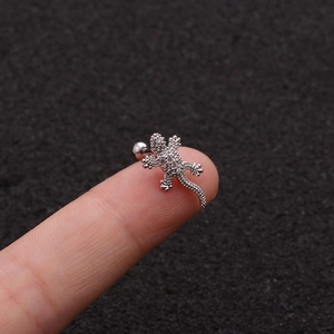 Detailed macro view of a silver gecko stud earring featuring pave-set cubic zirconia stones