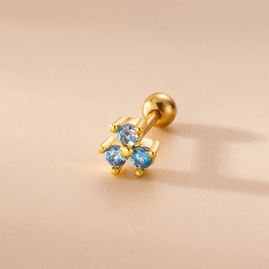 Close-up of blue zircon flower earring with gold screw ball back piercing detail
