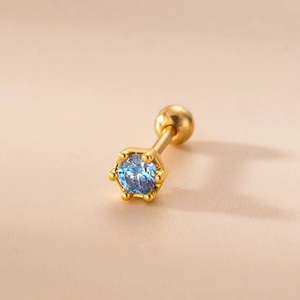 Detailed macro of gold plated stainless steel stud earring with blue zircon and screw back