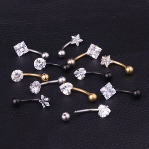 Macro detail of various zircon shapes and color finishes on stainless steel navel rings