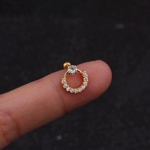 Close-up of golden stainless steel ear stud featuring sparkling zircon pave detail