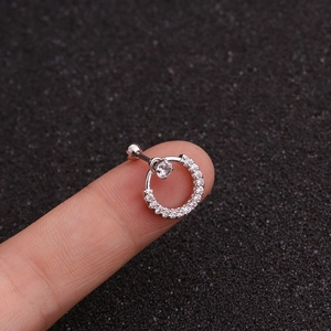 Close-up of silver piercing stud with circular cubic zirconia inlay on black foam