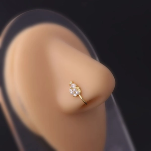 Close-up of gold nose clip with pearls and zircons on silicone nose model display