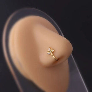 Detail view of a gold-plated flower non-piercing nose ring with micro-pave cubic zirconia