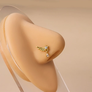 Clou de nez doré avec étoile et pendentif en zircone poire sur un modèle réel
