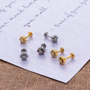 Macro detail of stainless steel labret studs with colorful zircon flower patterns