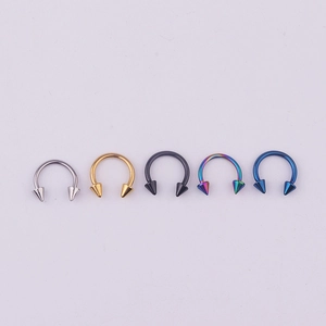 Macro detail of 316L stainless steel horseshoe rings in five different metallic colors