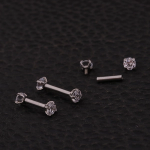 Macro view of 16G stainless steel labret studs with zircon stones and threaded components
