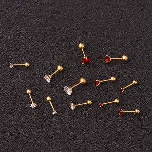 Detailed macro view of gold-plated 3-prong cubic zirconia screw back cartilage studs