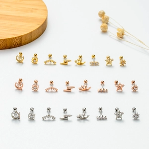 Macro shot of stainless steel earring set with zircon shapes and screw-back ball closure