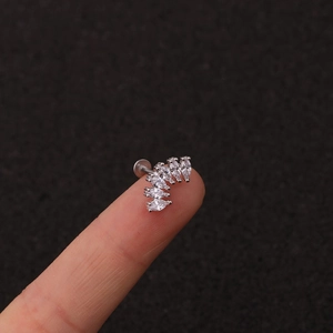 Silver crown labret stud with marquise crystals shown on fingertip for size reference