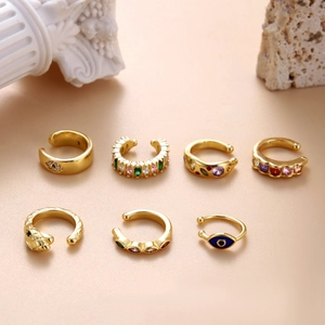 Set of 7 gold-plated snake and evil eye ear cuffs with colorful cubic zirconia accents