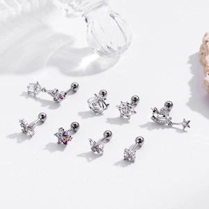 Macro view of colorful zircon flower and butterfly cartilage studs with screw ball backs