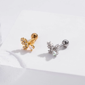 Detail of butterfly stud earring with opal and zircon inlay on a stone stand