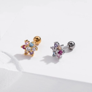 Detailed macro of colorful flower zircon ear studs with screw ball backs in gold and silver