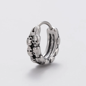 Punk style men's stainless steel hoop earring with detailed silver skull relief carvings