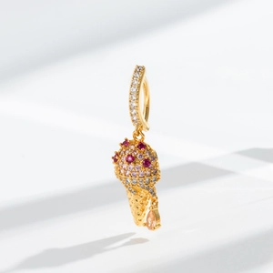 Detailed macro shot of an ice cream pendant navel ring with pink and red zircon stones