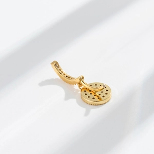 Macro view of a bohemian 18K gold-plated navel ring back with intricate micro-pave details