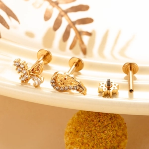 Detailed macro view of gold-plated butterfly labret with high-clarity cubic zirconia studs