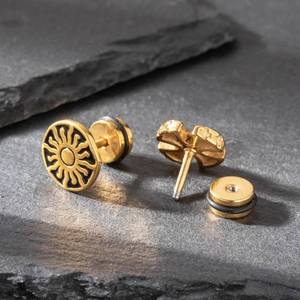 Men's gold steel skull earring with sunburst texture and secure screw back closure