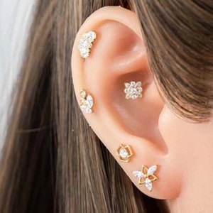 Titanium alloy earring set featuring flower and star studs with clear cubic zirconia