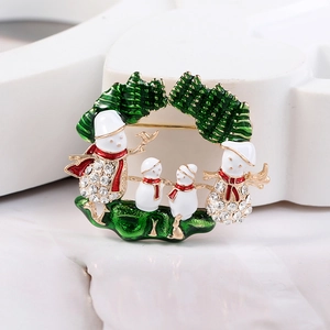 Vue détaillée de la broche famille bonhomme de neige avec émail rouge et strass brillants