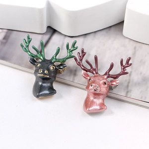 Detailed view of stylish 3D deer head brooches in black-green and pink-purple enamel colors