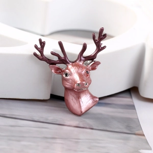 Detailed macro view of 3D reindeer brooch featuring pink enamel and purple antlers texture