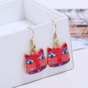 Artistic cat drop earrings with red patterns and gold metal hooks on white display