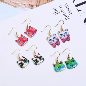 Set of four unique cartoon cat enamel drop earrings with colorful patterns and gold hooks