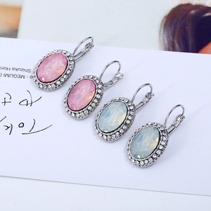 Detail of oval crystal leverback earrings with pink and white stones and rhinestone halo