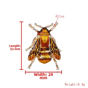 Detailed view of a golden insect cicada brooch with amber enamel wings measuring 32x24mm