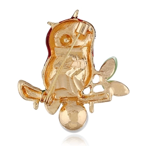 Detail view of owl brooch back with golden alloy finish and safety pin clasp