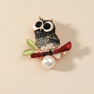 Creative owl brooch with enamel details, cat eye leaves and a large pearl pendant