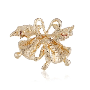 Back view of gold Christmas bell brooch showing secure metal pin clasp and textured finish