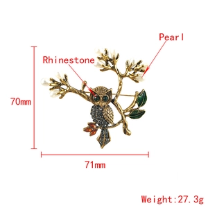Vintage owl brooch with rhinestones and pearls on a gold branch with size marks