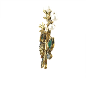 Vintage owl brooch with colorful enamel rhinestones and pearls on a golden branch