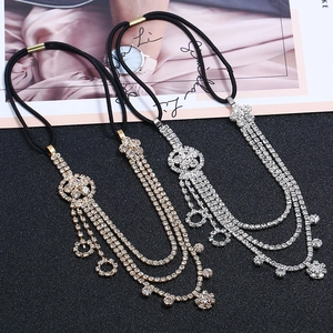 Detailed close-up of gold and silver flower hairbands with cascading rhinestone tassels