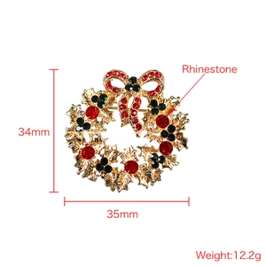 Sparkling Christmas wreath brooch with red bow and green rhinestones in golden alloy