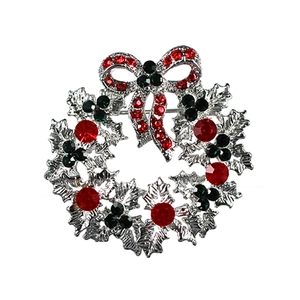Sparkling Christmas wreath brooch with silver bow and festive red green crystals